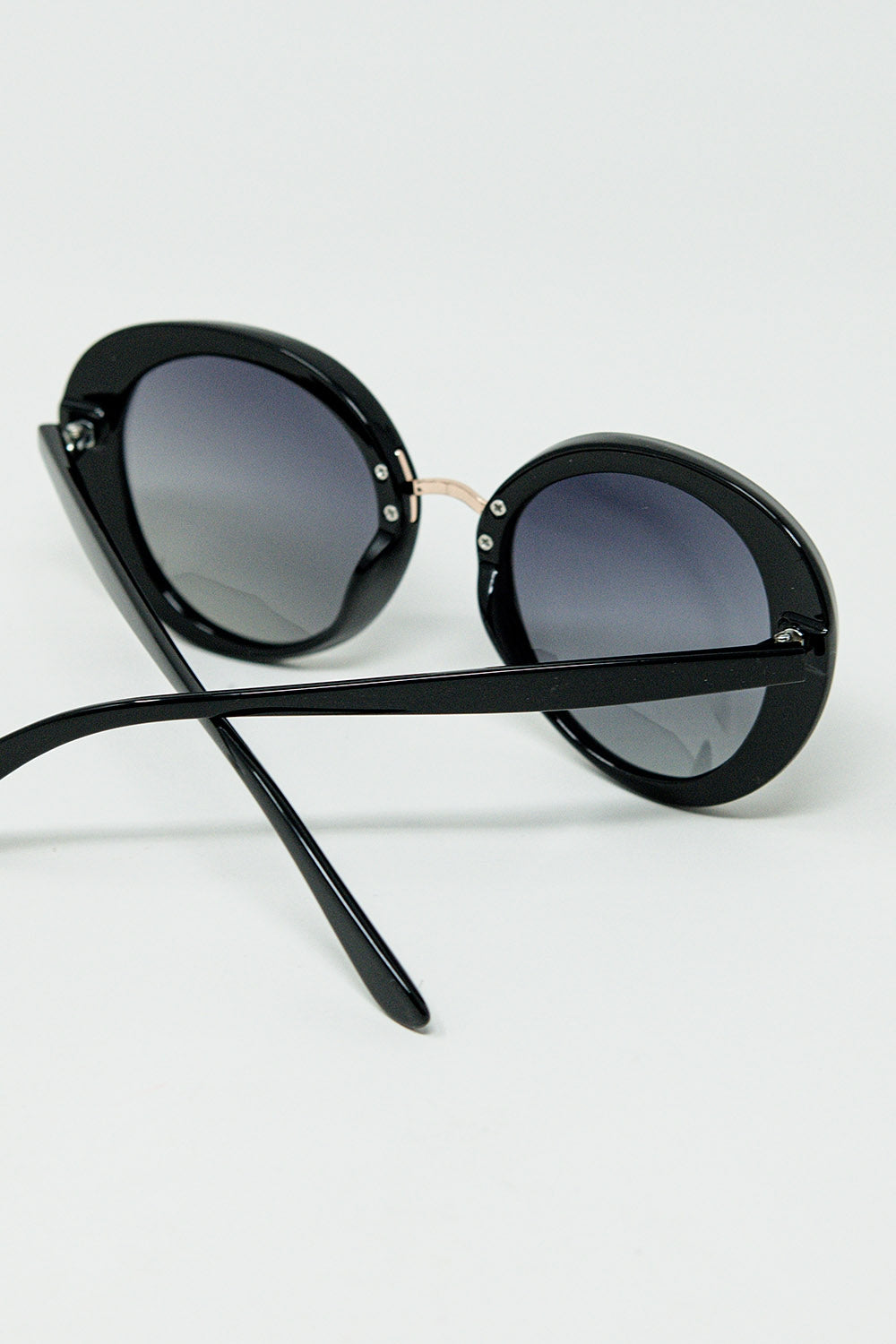 Black oval shaped sunglasses with metal gold detail | Just Cool Beans