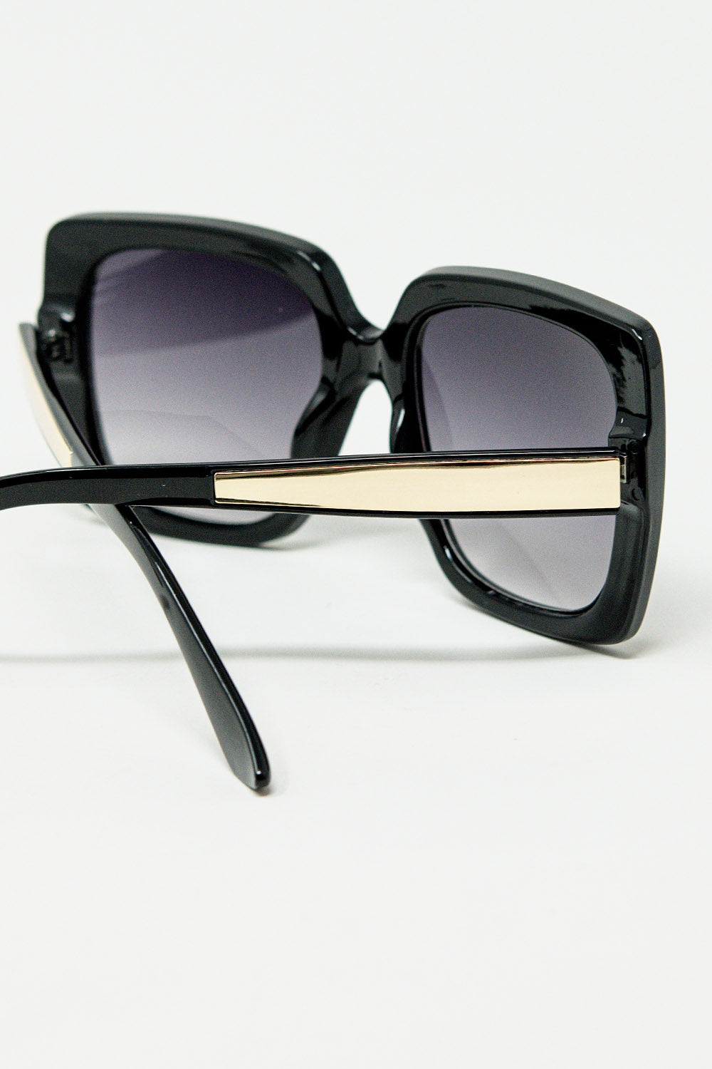 Black oversized square sunglasses with golden metallic detail | Just Cool Beans