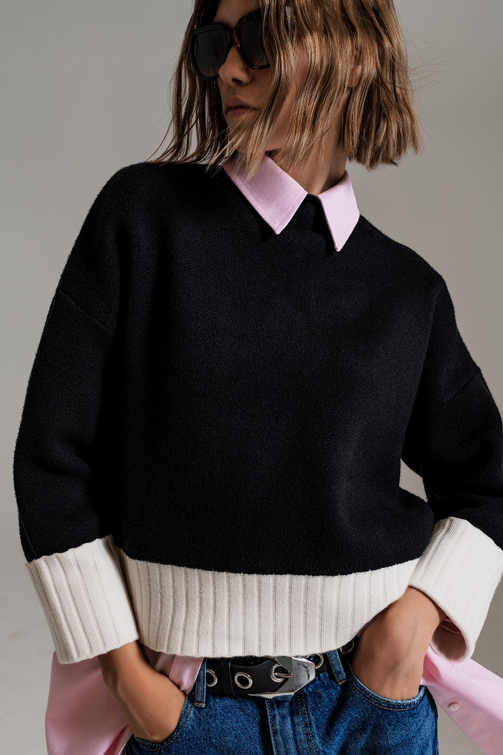 black jumper with white ribbed cuffs and hem