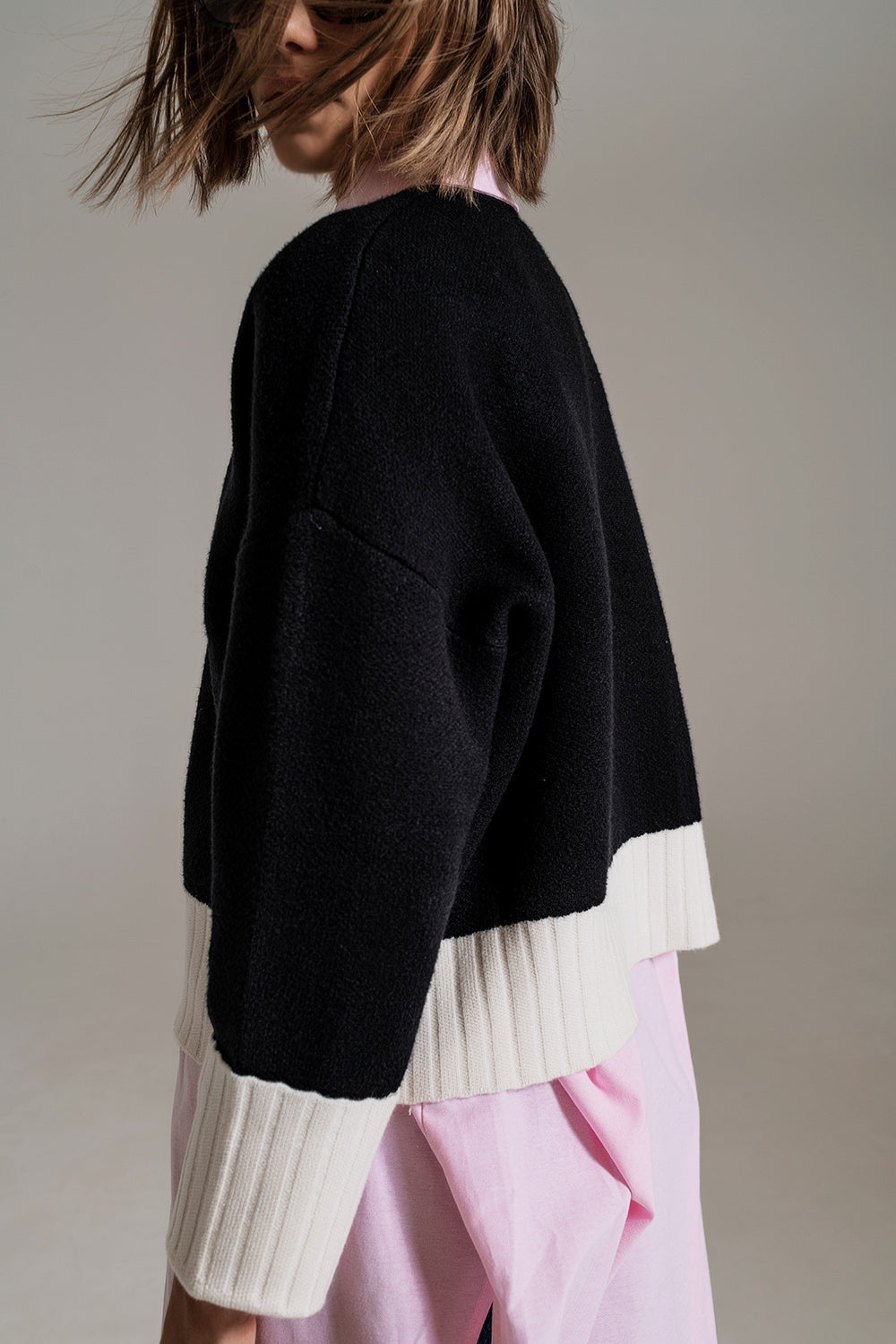 black jumper with white ribbed cuffs and hem