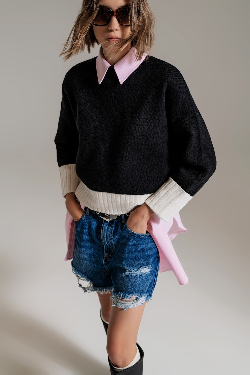 black jumper with white ribbed cuffs and hem