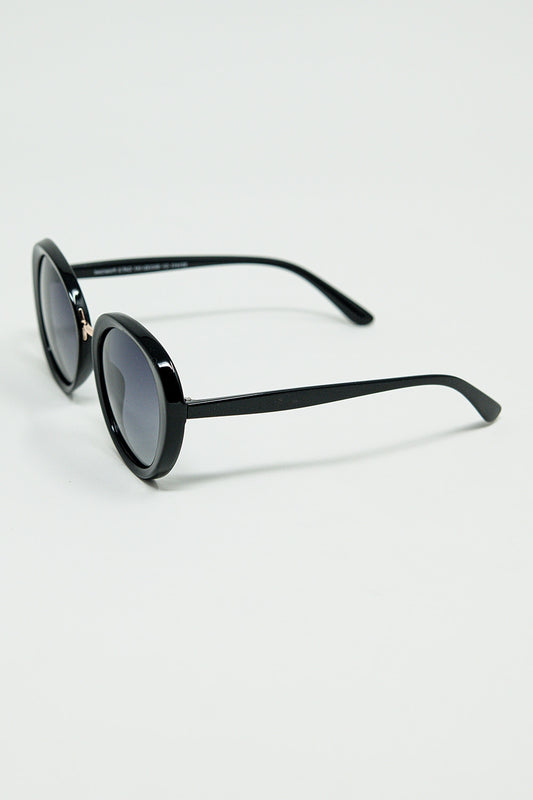 Black oval shaped sunglasses with metal gold detail | Just Cool Beans