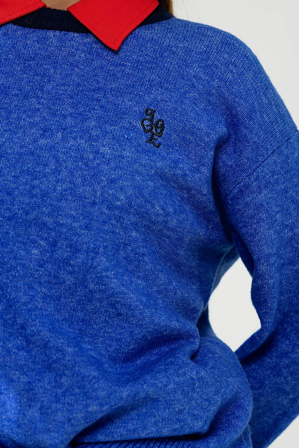 Blue sweater with contrasting collar and love logo on chest