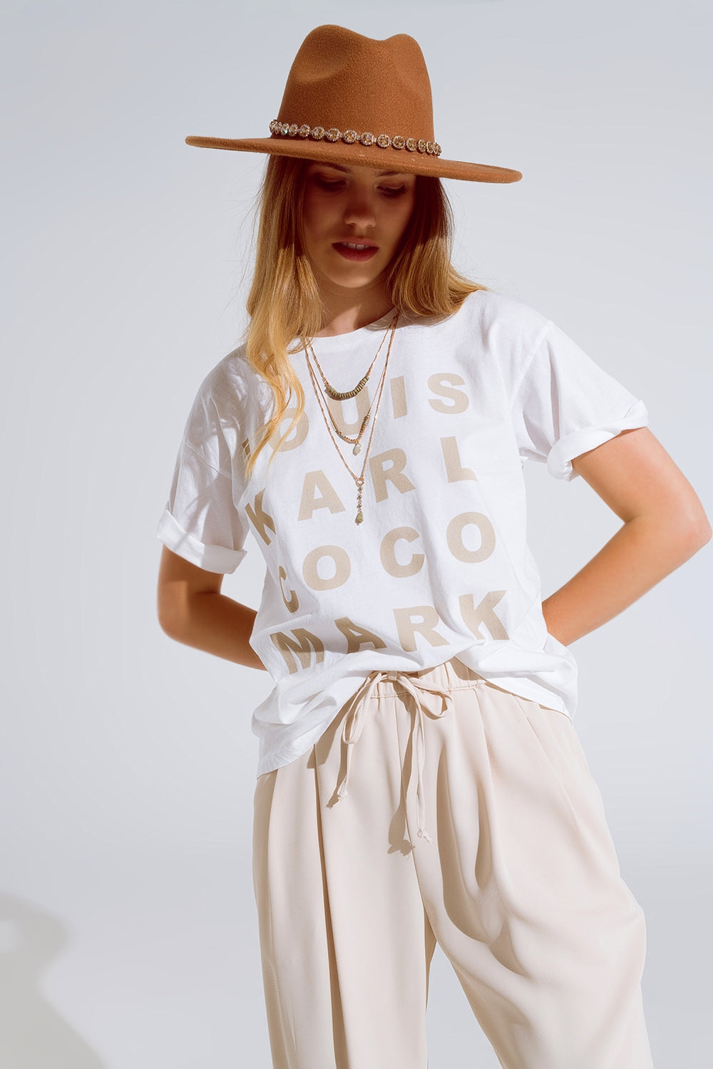 Creme t-shirt with famous names logos at the front | Just Cool Beans — tops