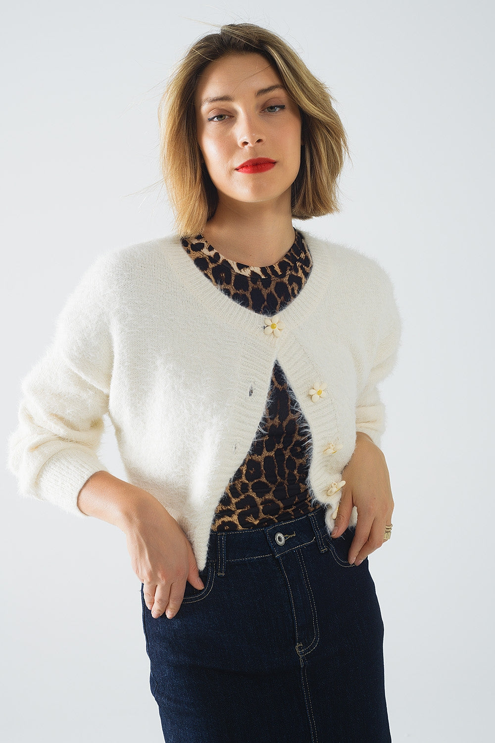 Short and fluffy cream cardigan with flower buttons | Just Cool Beans — sweaters | bottoms