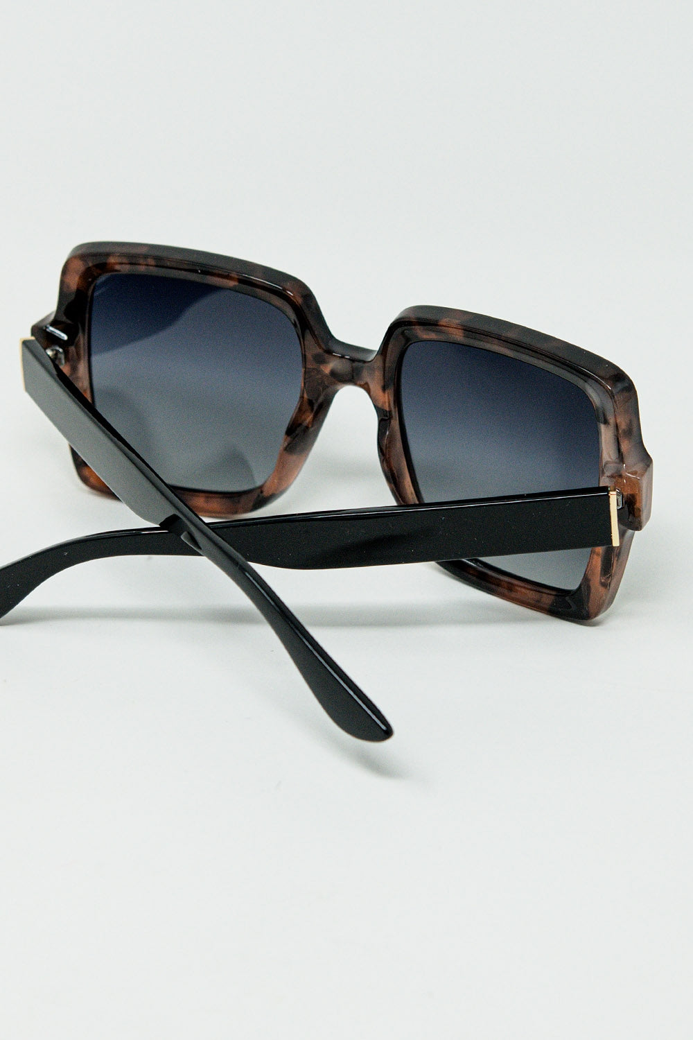Sunglasses with a brown print frame and black temples | Just Cool Beans