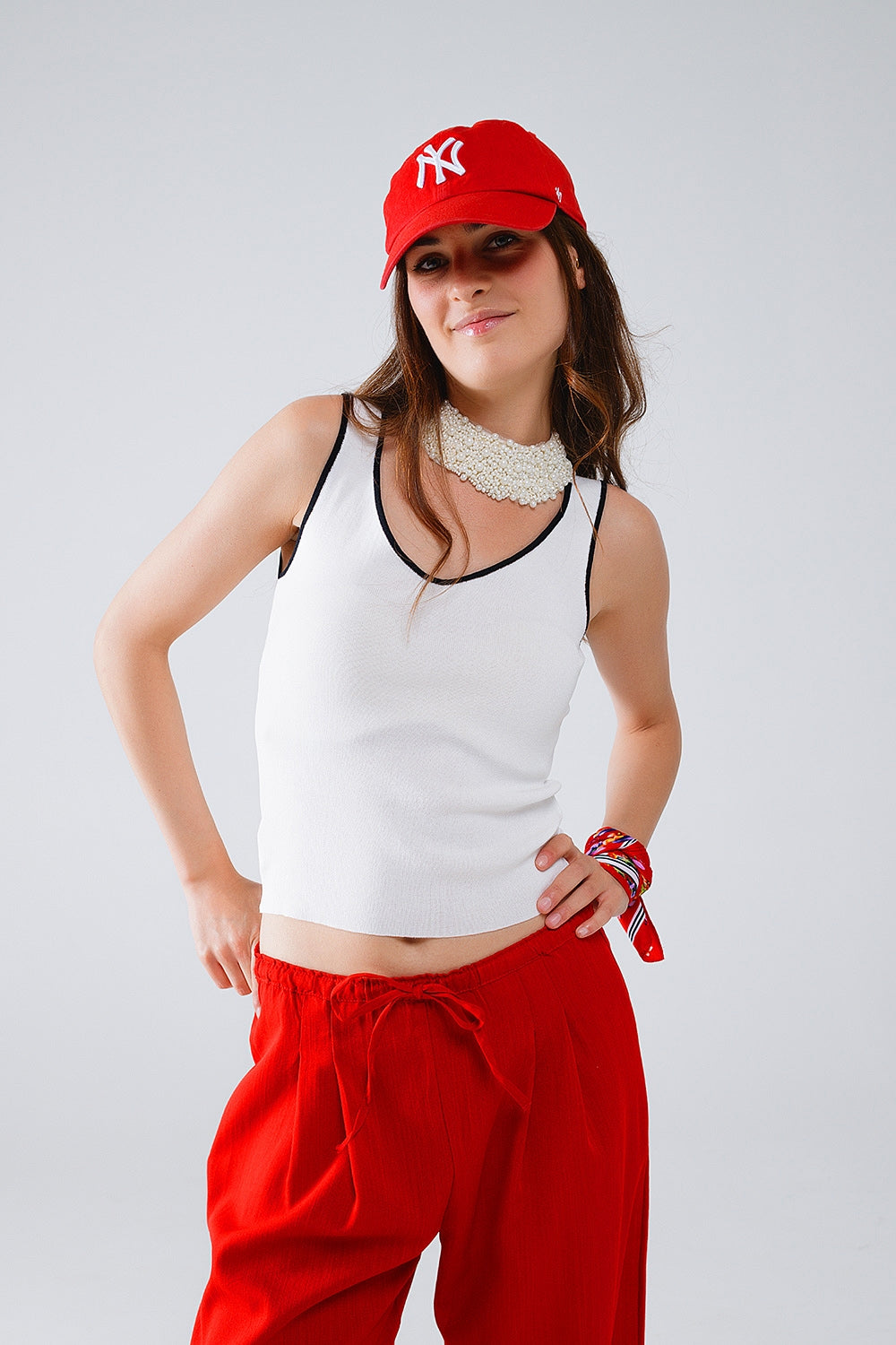 White sleeveless top with crew neckline neckline and black trim | Just Cool Beans — sweaters | tops